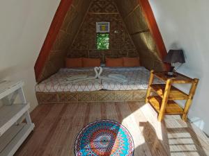 A bed or beds in a room at Glamping Alona