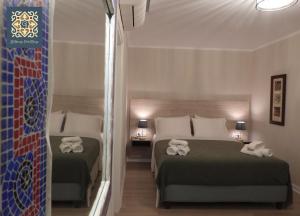 A bed or beds in a room at Saint george Hotel Parga