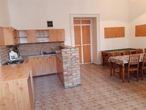 a kitchen and dining room with a table and a kitchen and a dining room at 20 Bakancs Apartman in Esztergom