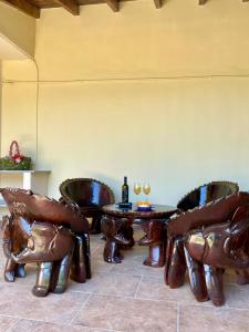 a room with leather chairs and a table with wine glasses at Casa Sophia in Karavostamo