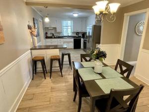 a kitchen and dining room with a table and chairs at The Yellow Cottage By Tims Ford Lake in Winchester
