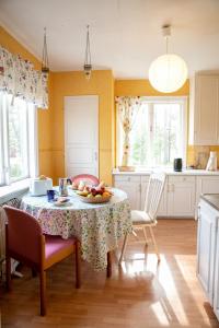 a kitchen with a table with a bowl of fruit on it at Cozy Home in Ydrefors in Ydrefors