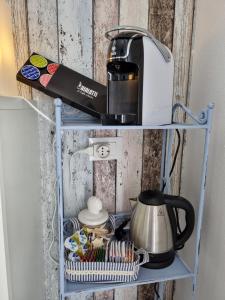 a coffee maker on a shelf on a wall at Residenza Azzurra in Cattolica
