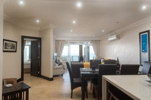 a dining room with a table and chairs and a living room at Ballito Manor View 503 - With Generator in Ballito