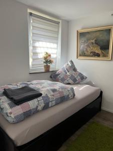 a bed with a quilt on it in a bedroom at GOLDSTADT LOUNGE in Pforzheim