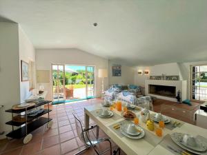 a living room with a table and a couch at Albufeira Balaia Villa With Private Pool by Homing in Albufeira