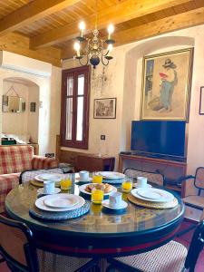 a dining room with a table with dishes on it at Kleopatra's House in Karavostamo