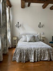 a bedroom with a white bed with pillows at Hôtel de la Cathédrale Metz in Metz +48 photos