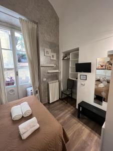 a bedroom with a bed with two towels on it at Marcelina vaticans rooms in Rome