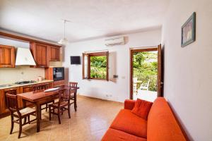 a kitchen and dining room with a couch and a table at SOLEMAREPONZA Casa il Bacio del Sole in Ponza