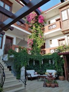 a building with a staircase with flowers and plants at Hotel Mary's House in Selcuk