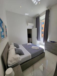 a bedroom with a bed in a white room at GUVANO Luxury Apartments in La Spezia