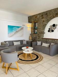 a living room with a couch and a table at Esperides in Platis Gialos