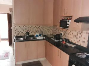 a kitchen with a sink and a microwave at Cabanas Del Mar 31 in Kingsborough