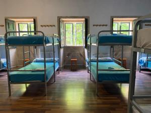 a group of bunk beds in a room at La Calabaza del Peregrino in O Faramello
