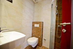 a bathroom with a toilet a sink and a bathtub at Hostel Franz Ferdinand in Sarajevo