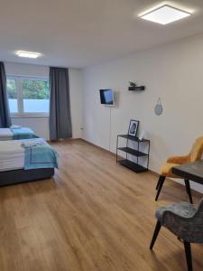 a bedroom with a bed and a table and chairs at Twitch Appartments in Achim