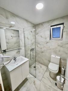 W łazience znajduje się toaleta, umywalka i prysznic. w obiekcie Relax Mea Hotel w Sarandzie