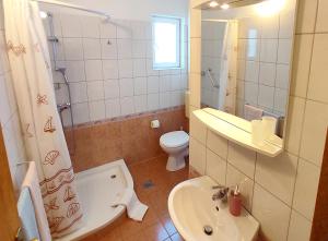 a bathroom with a sink and a toilet and a shower at Apartments Martin in Drvenik +15 photos