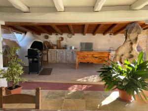 a large living room with a kitchen with a table at Villetta Santa Maria in Orosei
