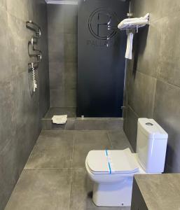 a bathroom with a toilet and a shower at Pallada Hotel in Ternopilʼ
