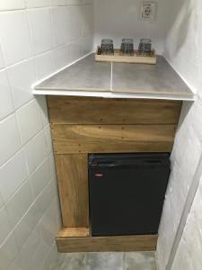 a small kitchen with a counter and a dishwasher at Habitación independiente en casa antigua - Centro in Utrera