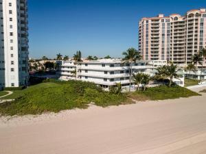 a beach with two tall buildings and palm trees at Ocean Ocean Ocean International Studio 209 in Pompano Beach