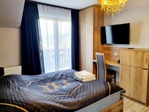 Postel nebo postele na pokoji v ubytování Willa "KomaNcza" Szczawnica