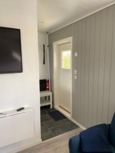 a living room with a flat screen tv on a wall at Feriehus med Sjøutsikt in Sætra