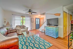 a living room with a couch and a blue dresser at Cozy Auburn Retreat with Hot Tub - Walk to Lake in Auburn
