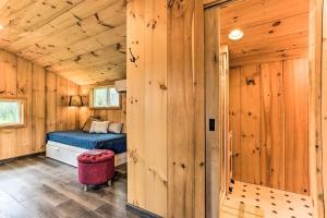 a bedroom with a bed in a wooden cabin at Cozy Upstate Studio with Walkill River Views! in New Paltz