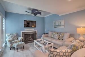 a living room with a couch and a fireplace at Poolside Madeira Beach Abode with Balcony! in St. Pete Beach