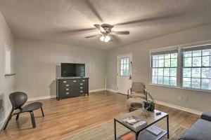 an empty living room with a couch and a tv at Pet Friendly Gainesville Getaway about 2 Mi to UF in Gainesville