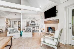 a living room with white furniture and a fireplace at Seascape 3559 in Kiawah Island