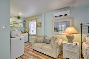a living room with a couch and a kitchen at Dreamy, Coastal Studio Paradise with Hot Tub! in Nags Head