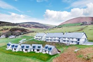 an aerial view of a row of houses in the hills at 2 Bed Penthouse Apartment - 10 Plas in Pistyll