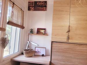 a room with a window and a table with a lamp at UN OASIS EN PROVENCE in Aubagne +28 photos