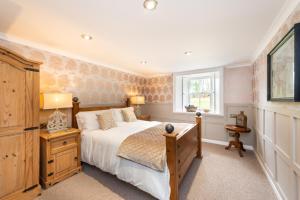 a bedroom with a bed and a window at Blanerne House in Duns