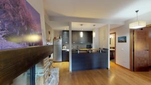 a kitchen and a living room with a counter top at Los Altos de Escarrilla - tucasaenlospirineos in Escarrilla