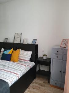 a bedroom with a bed and a dresser with a night stand at Arsan home in Cluj-Napoca