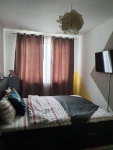 a bedroom with a bed in front of a window at Arsan home in Cluj-Napoca