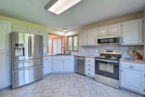 a kitchen with white cabinets and stainless steel appliances at Coloma Escape Pool, Hot Tub Less Than 1 Mi to Lake! in Coloma