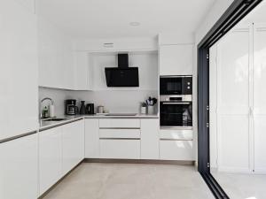 A kitchen or kitchenette at Brand new Exclusive apartment, 150 meter from the Beach