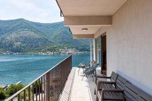 a balcony with chairs and a view of the water at Olga's Piece of Paradise in Kotor in Kotor