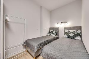 a bedroom with two beds and a mirror at Central Platinum Apartments 25 in Rybnik