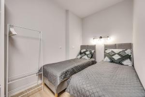 a bedroom with two beds and a mirror at Central Platinum Apartments 25 in Rybnik