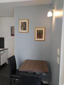 a dining room with a table and two pictures on the wall at AUBERGE LE GABACHOU in Montpezat-de-Quercy