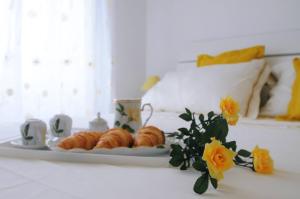 a plate of croissants on a table in a room at Guesthouse Adriana Cottages in Labin
