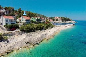an aerial view of a beach with houses at Apartments Blueness in Prigradica