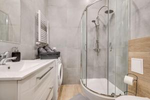 a bathroom with a shower and a sink and a toilet at Central Platinum Apartments 29 in Rybnik +24 photos